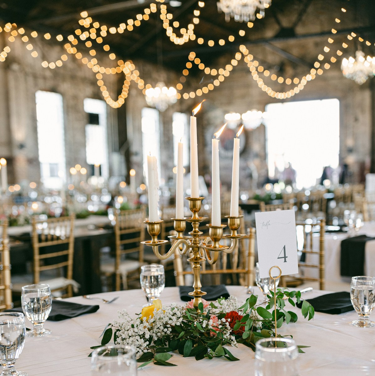 A table with a white table cloth and a chandelier